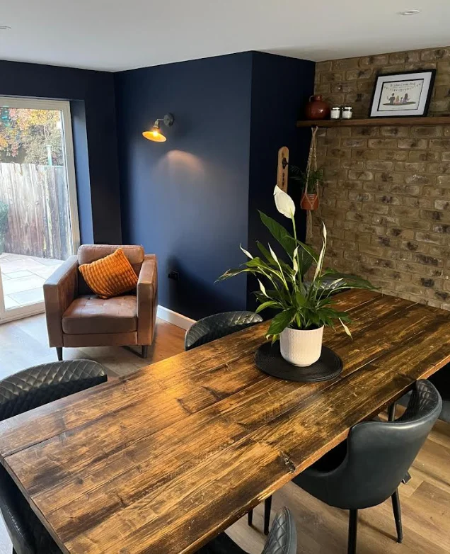 Navy dining room with feature brick wall