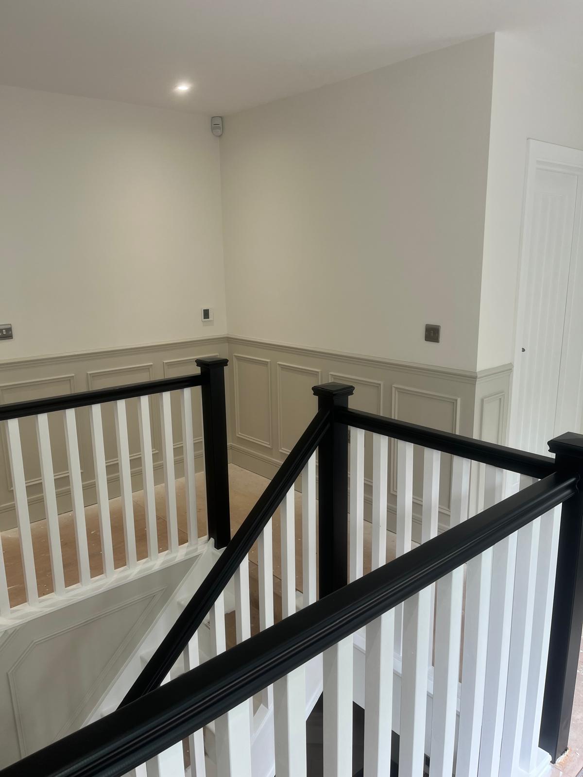 Bright landing with black newel post
